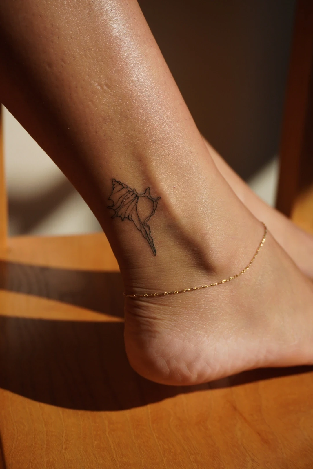 Fine line školjka na vanjskoj strani gležnja — tetovirala Anastasia Kulikova u Zagrebu
